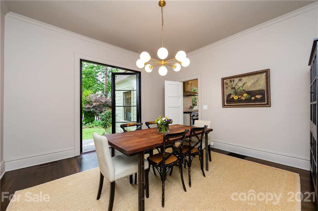 2230 Sharon Road Charlotte, NC 28207 - Photo 16 of 43 a view of a dining room with furniture and a chandelier