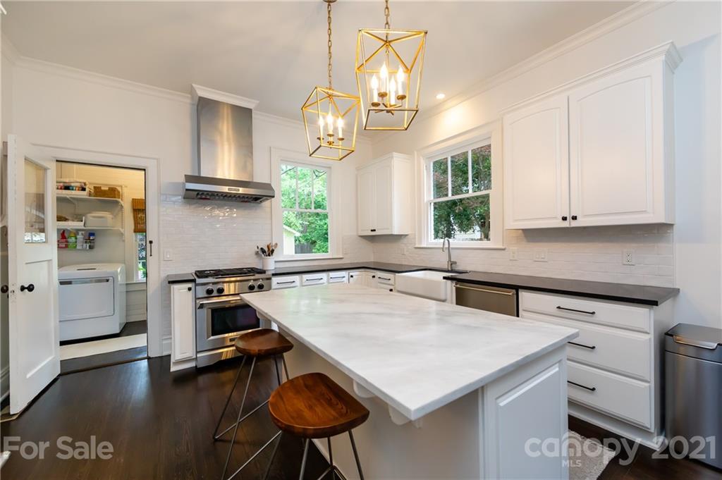 2230 Sharon Road Charlotte, NC 28207 - Photo 18 of 43 a kitchen with stainless steel appliances granite countertop a sink a stove and a refrigerator
