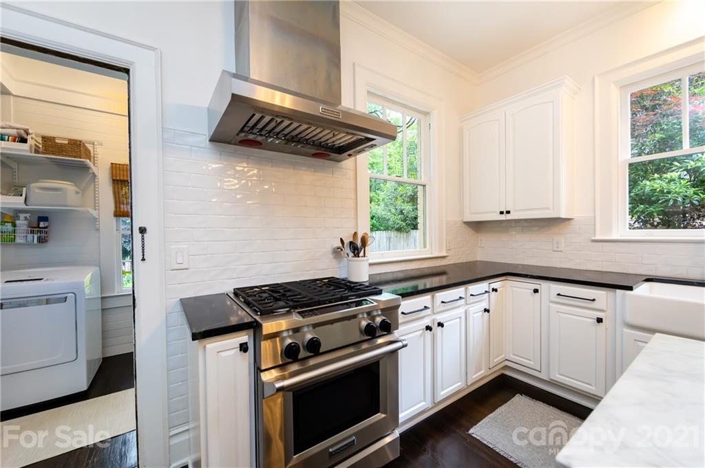 2230 Sharon Road Charlotte, NC 28207 - Photo 19 of 43 a kitchen with a stove a sink and a window