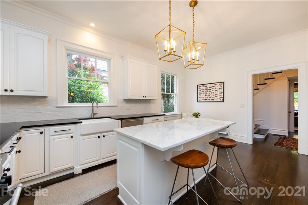 2230 Sharon Road Charlotte, NC 28207 - Photo 21 of 43 a kitchen with a table chairs and white cabinets