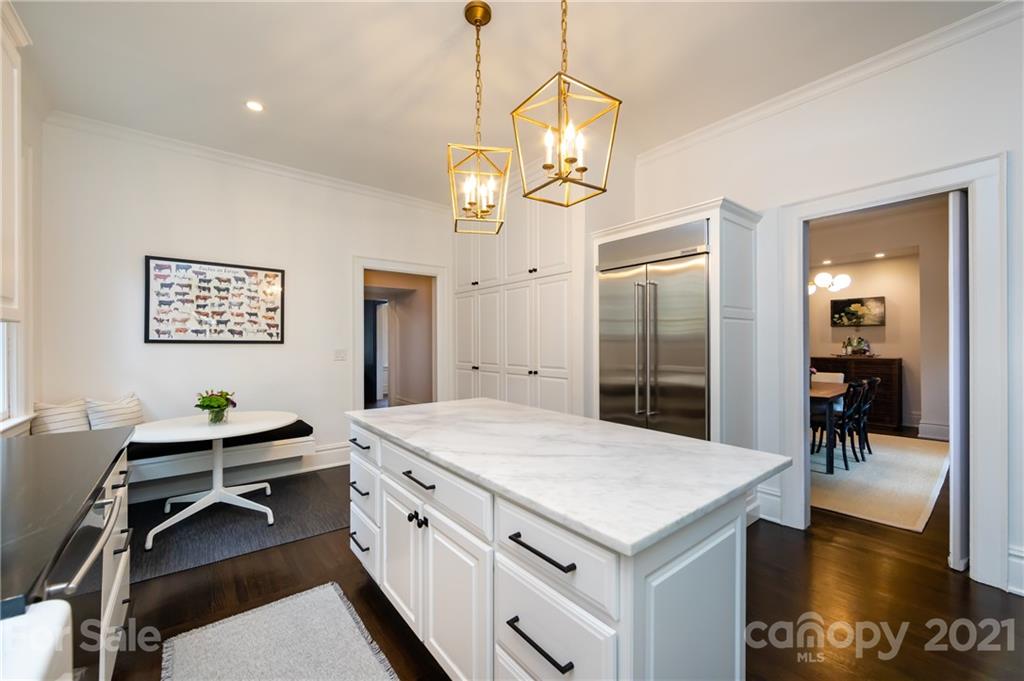 2230 Sharon Road Charlotte, NC 28207 - Photo 22 of 43 a kitchen with a table chairs and chandelier