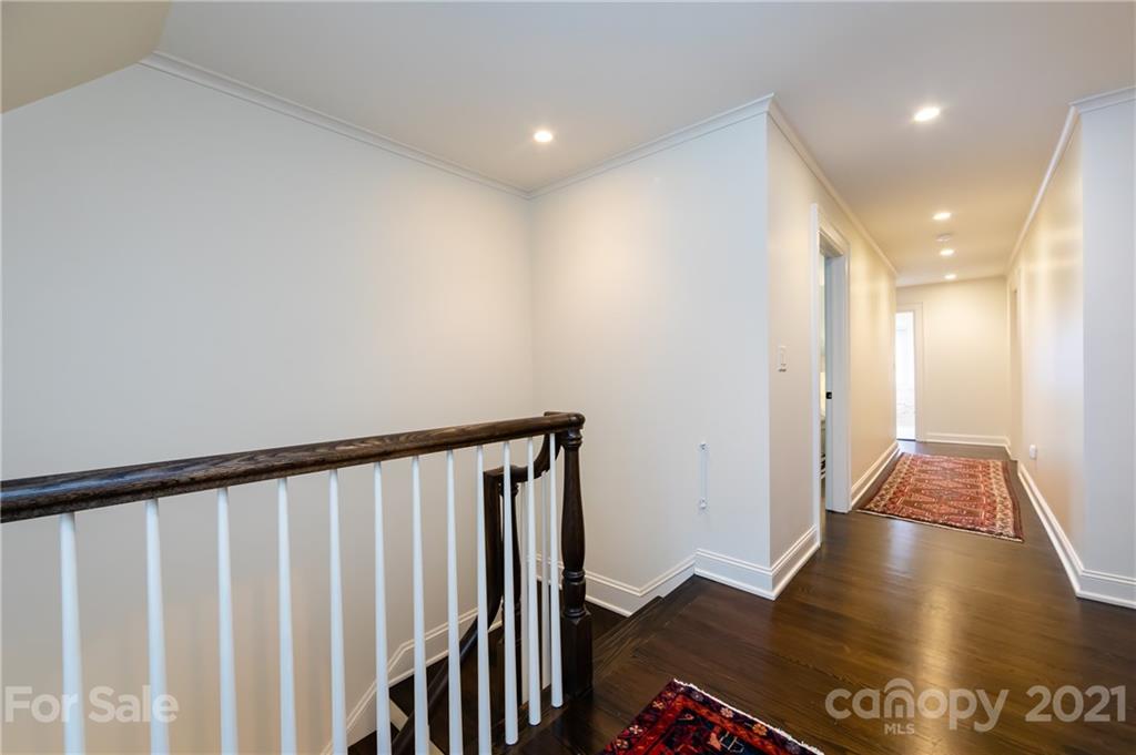 2230 Sharon Road Charlotte, NC 28207 - Photo 29 of 43 a view of a hallway with wooden floor and staircase