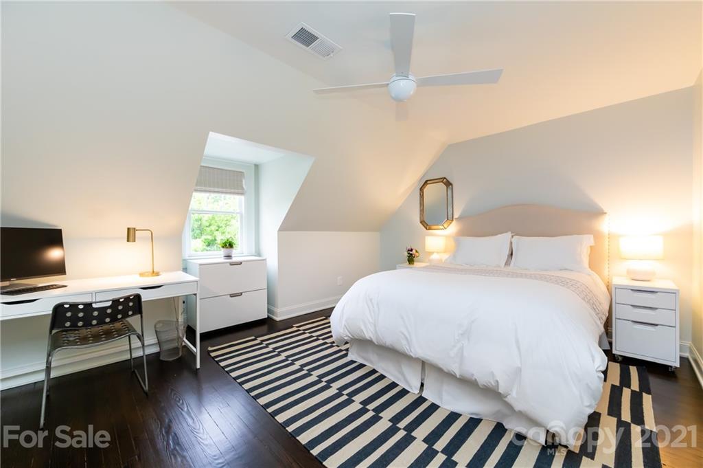 2230 Sharon Road Charlotte, NC 28207 - Photo 30 of 43 a bedroom with a bed wooden floor and a window