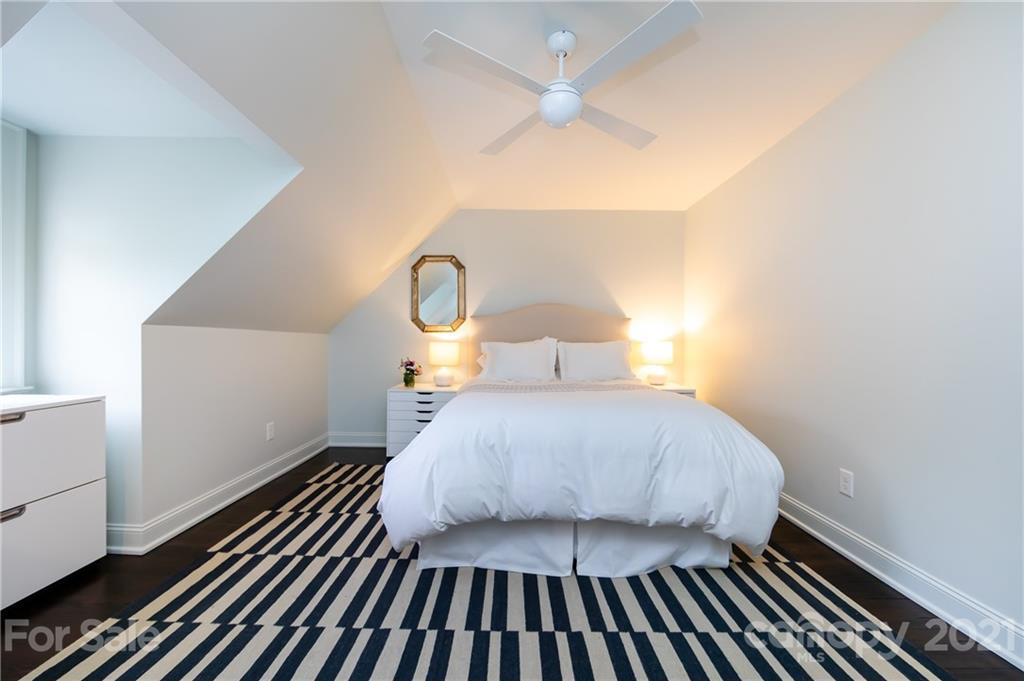 2230 Sharon Road Charlotte, NC 28207 - Photo 31 of 43 a bedroom with a bed and wooden floor