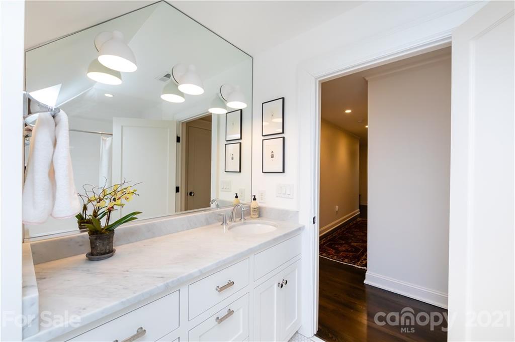 2230 Sharon Road Charlotte, NC 28207 - Photo 34 of 43 a bathroom with a sink a vanity and a mirror