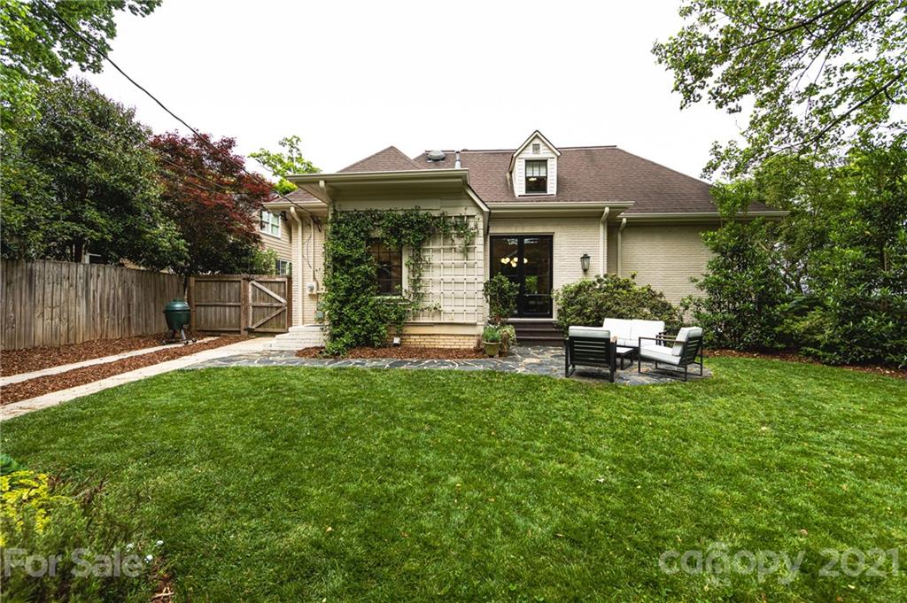 2230 Sharon Road Charlotte, NC 28207 - Photo 40 of 43 a front view of a house with a garden and chairs