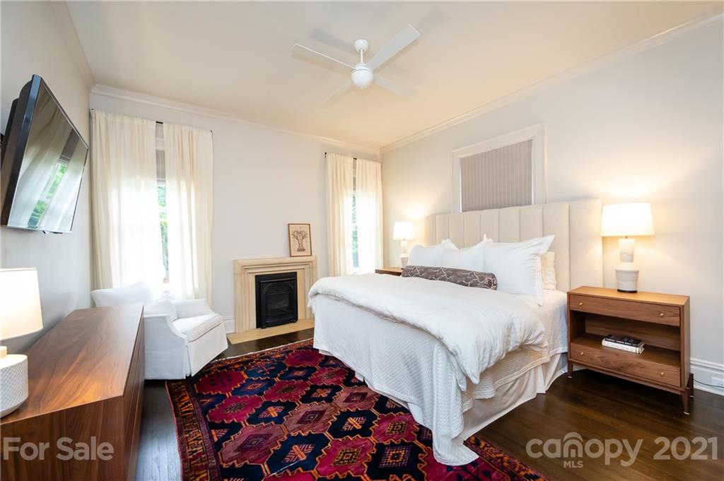 2230 Sharon Road Charlotte, NC 28207 - Photo 7 of 43 a bedroom with a bed and a fireplace
