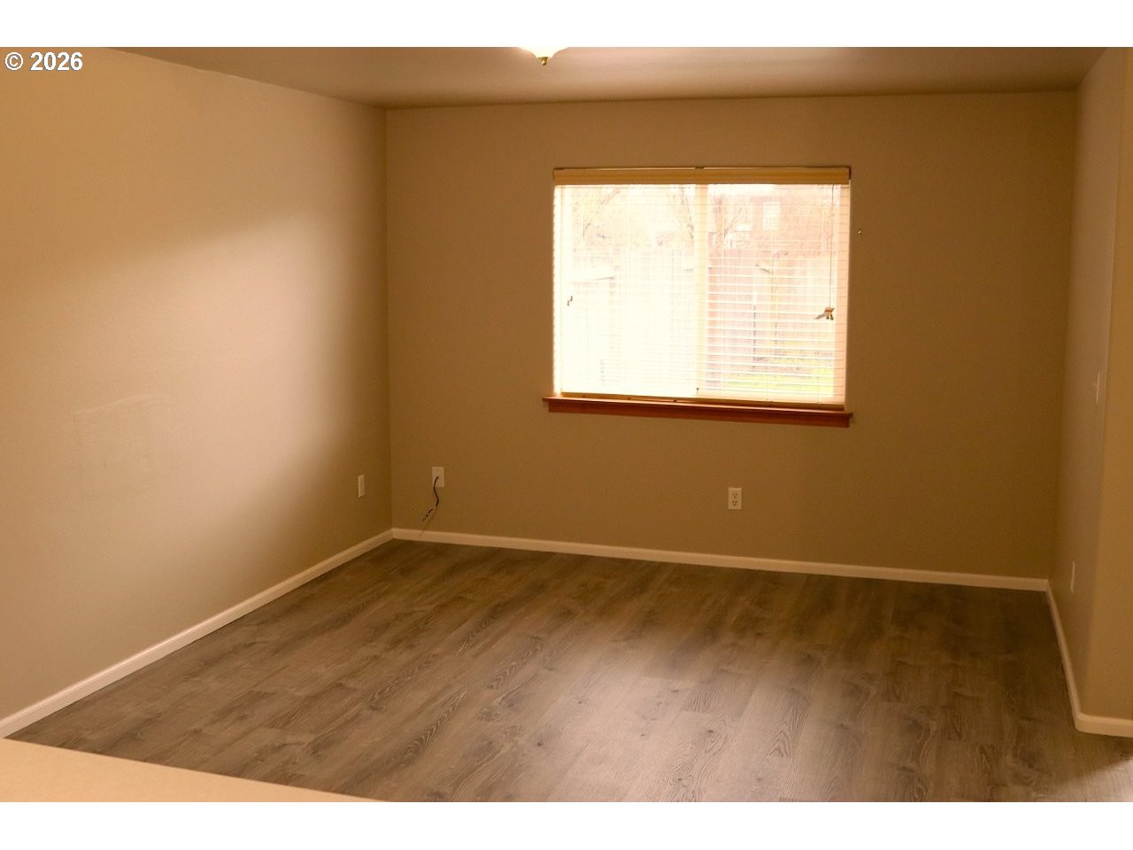 460 Autumn Avenue Eugene, OR 97404 - Photo 2 of 21 an empty room with wooden floor and windows