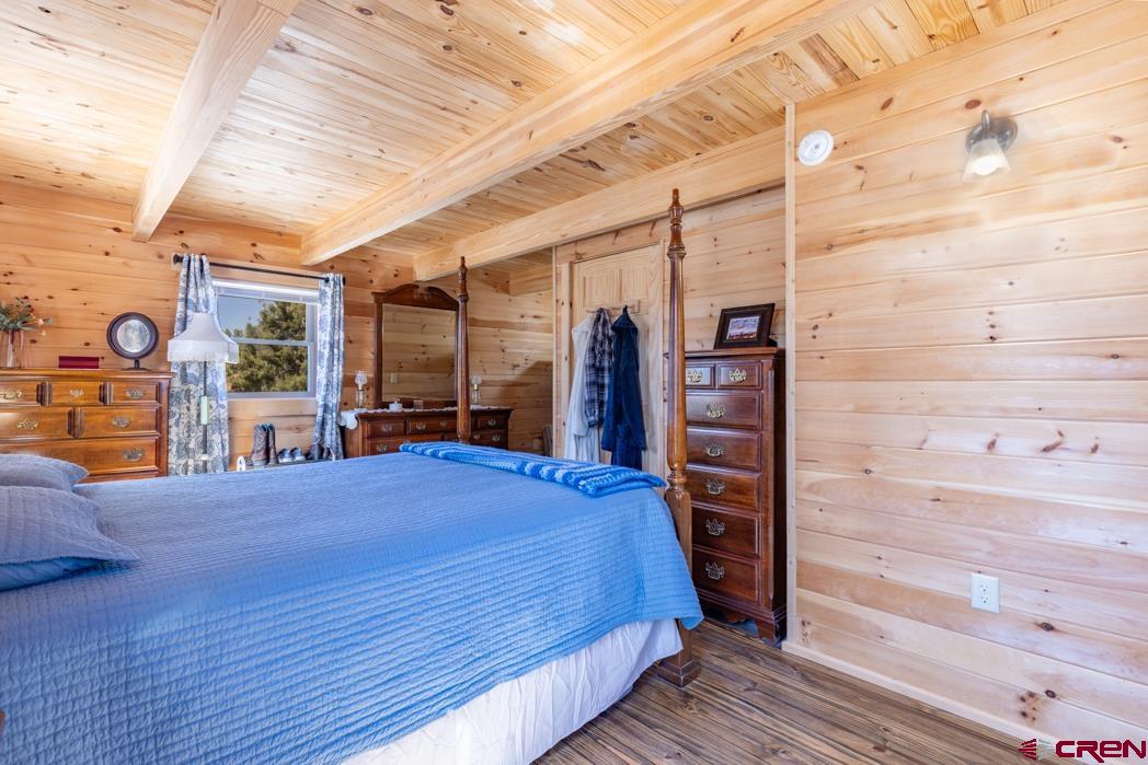 553 Cow Canyon Road Ignacio, CO 81137 - Photo 10 of 34 a bedroom with a bed and a flat tv screen