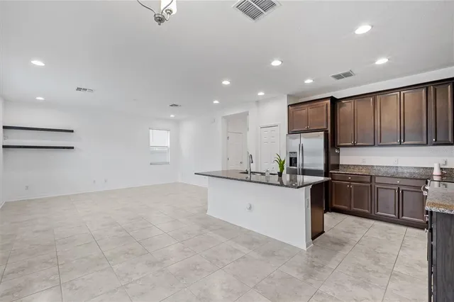 a kitchen with stainless steel appliances granite countertop a stove and a sink