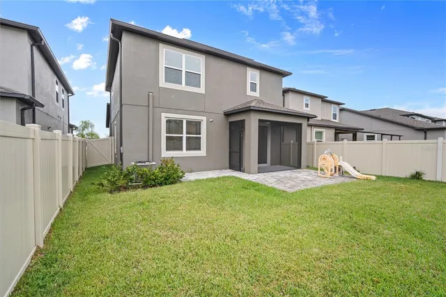 a view of a house with backyard and porch