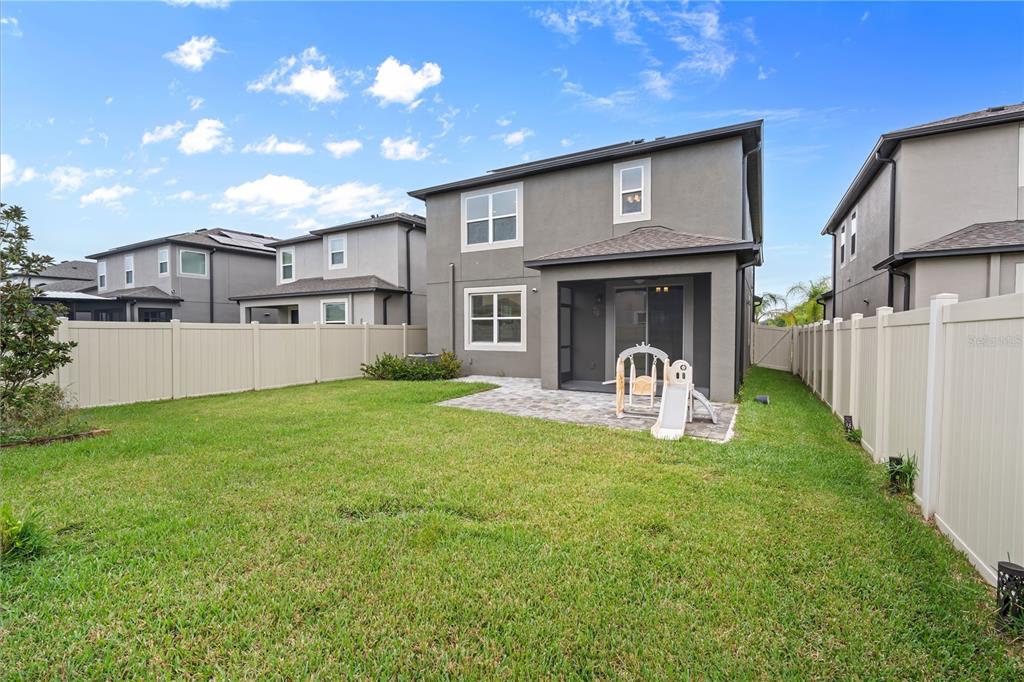 37820 Beacon Brick Drive Zephyrhills, FL 33540 - Photo 23 of 26 a view of a house with backyard and sitting area