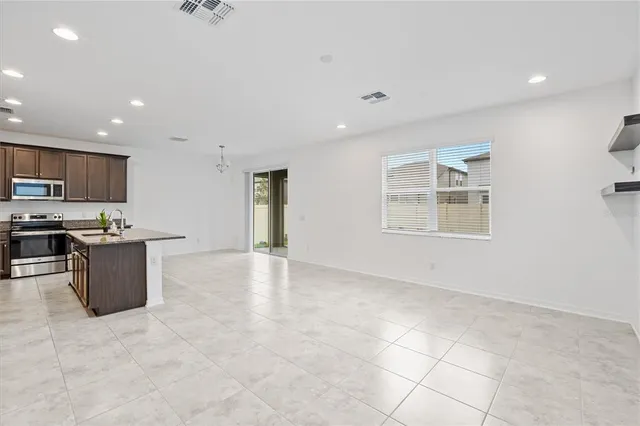 a view of kitchen with stainless steel appliances cabinets