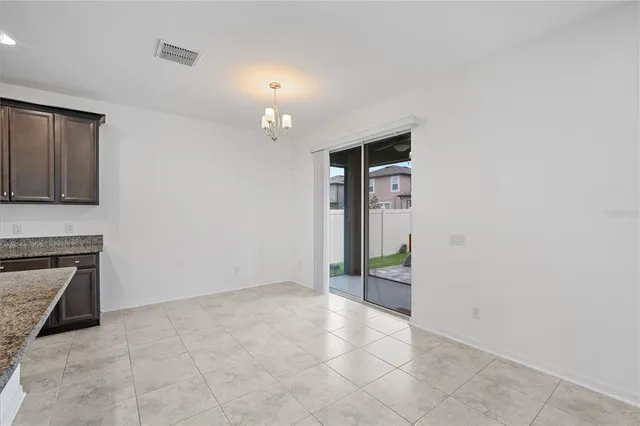 an empty room with windows and entrance