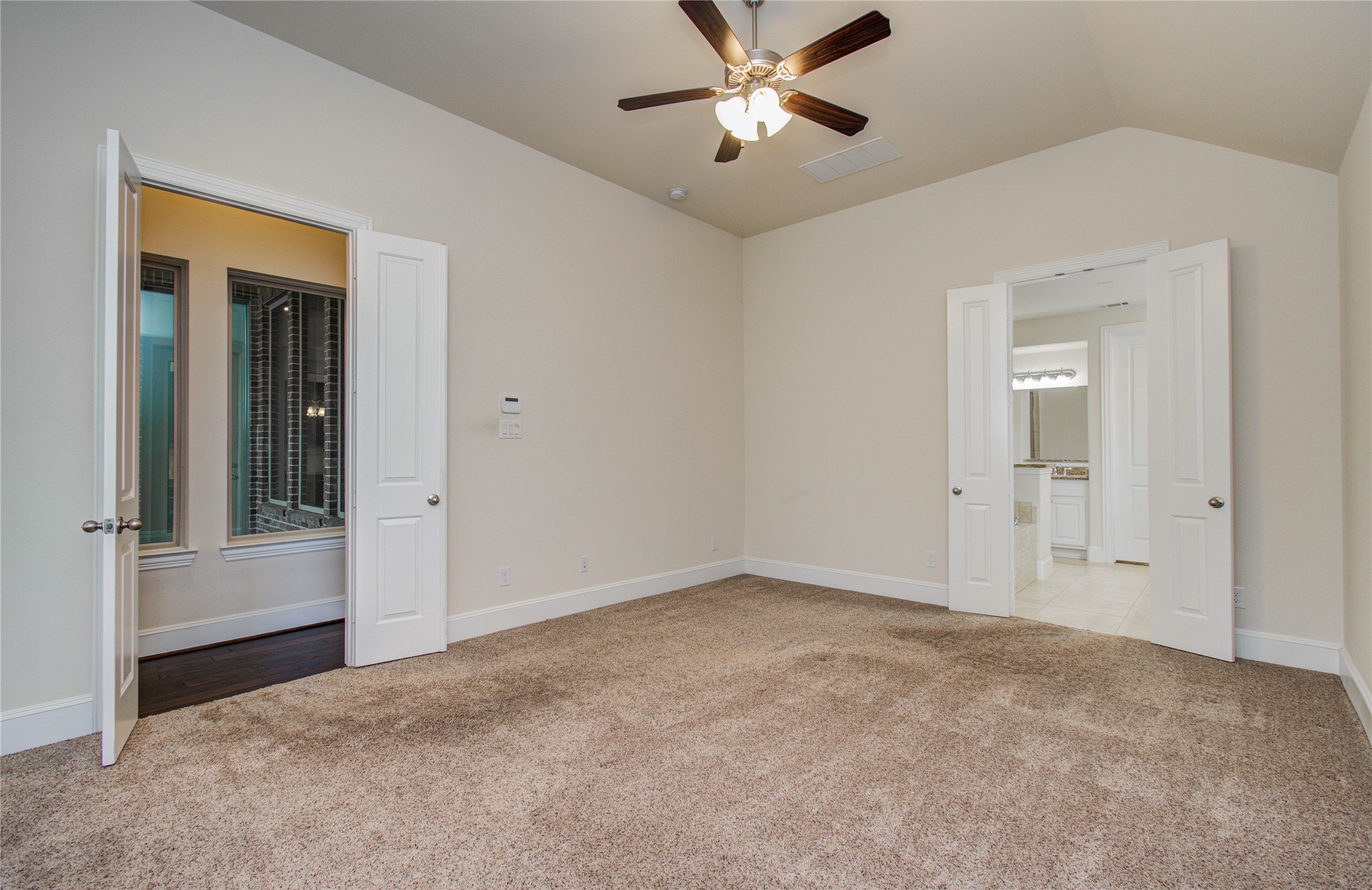10202 South Goshawk Trail Conroe, TX 77385 - Photo 19 of 50 The primary bedroom has plenty of space, windows that overlook the yard and garden, and a bathroom fit for a King and/or Queen.