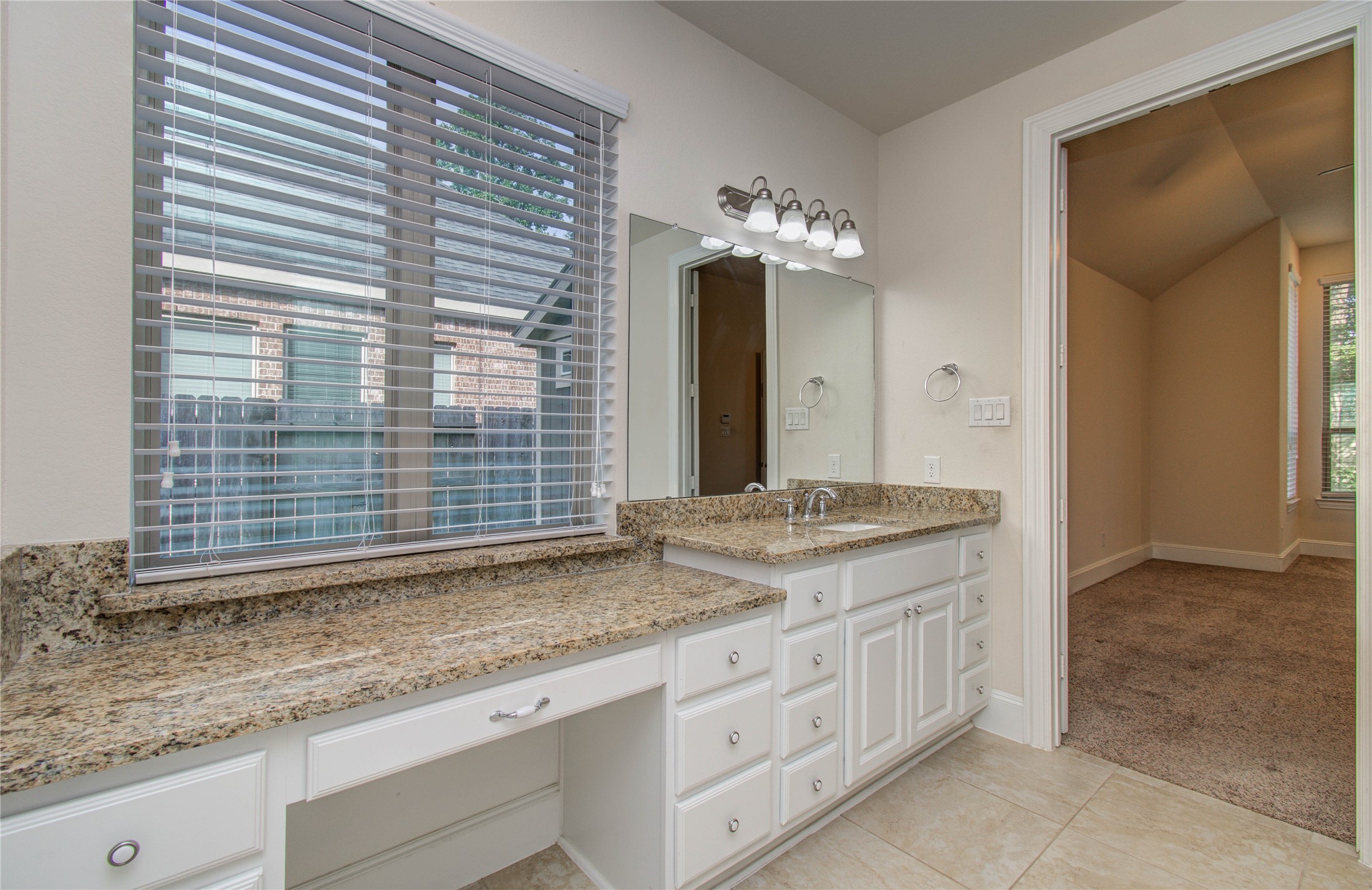 10202 South Goshawk Trail Conroe, TX 77385 - Photo 21 of 50 The primary bedroom has plenty of space, windows that overlook the yard and garden, and a bathroom fit for a King and/or Queen.