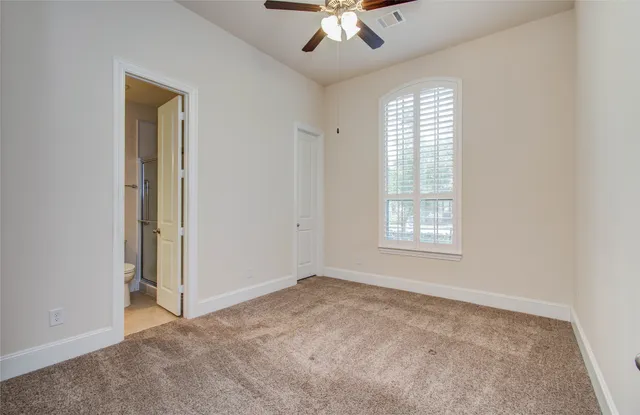 a bathroom with a toilet a sink a mirror and vanity