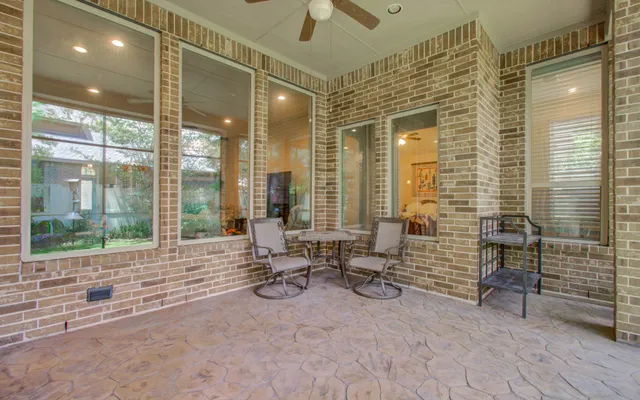 a backyard of a house with barbeque oven and outdoor seating