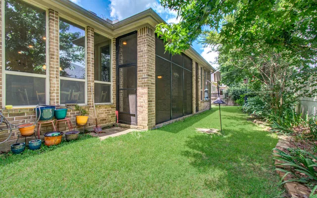 a view of a house with a yard and porch