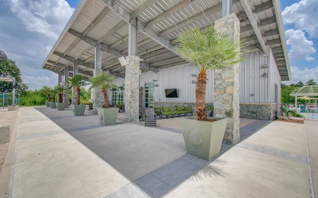 a view of a patio with a table and chairs and a barbeque