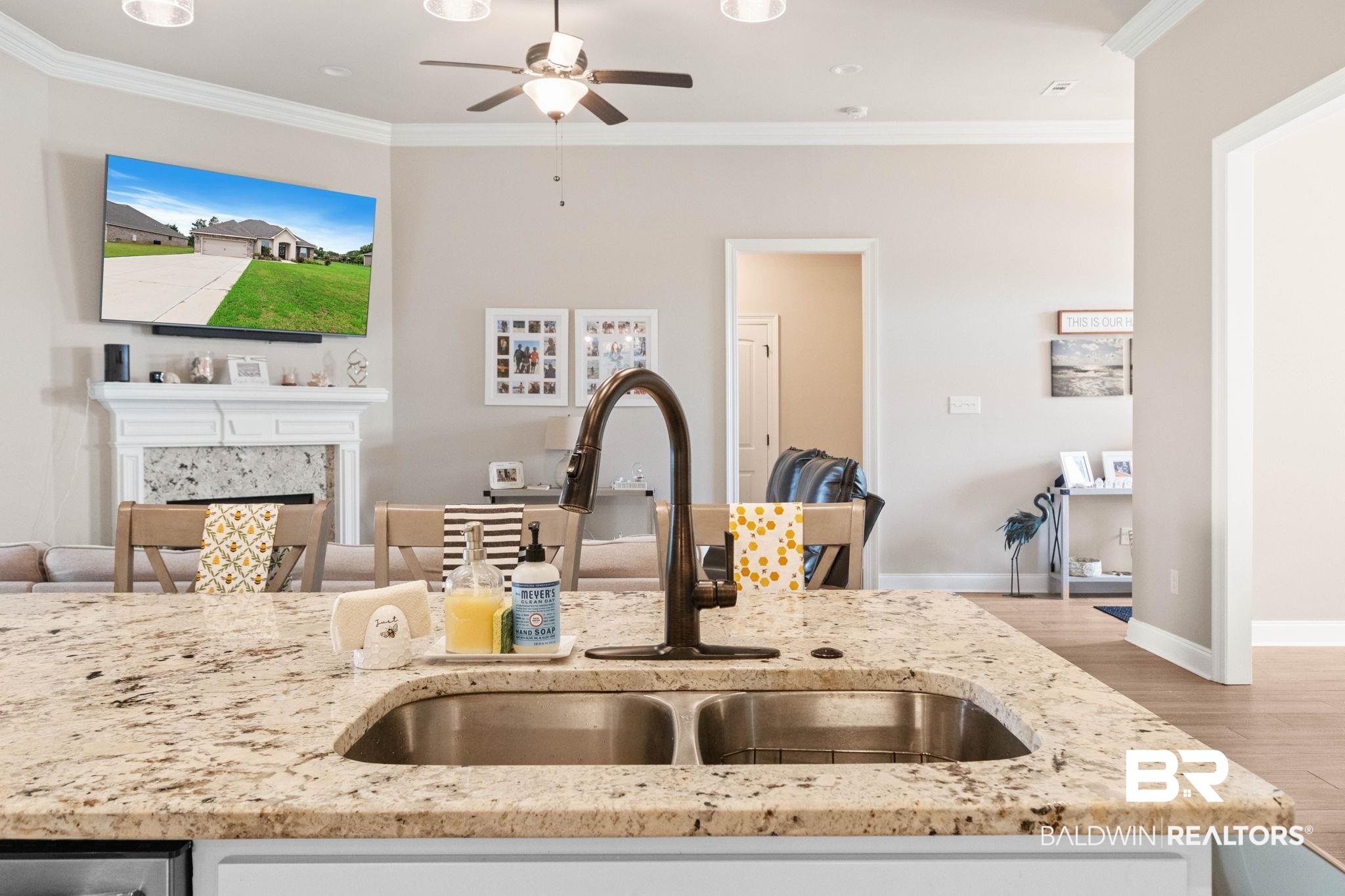 22244 Hibiscus Circle Foley, AL 36535 - Photo 27 of 51 Granite countertop island with an undermount double-basin sink and a gooseneck faucet