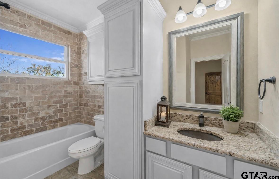 14740 Fm 1255 Canton, TX 75103 - Photo 11 of 40 a bathroom with a granite countertop sink a toilet a mirror and bathtub