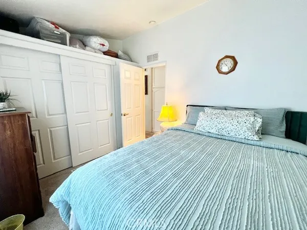 a bedroom with a bed and a cabinets