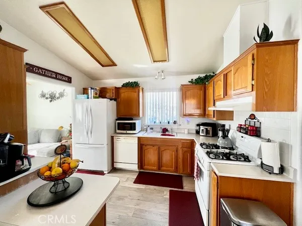 a room with furniture a refrigerator and a sink