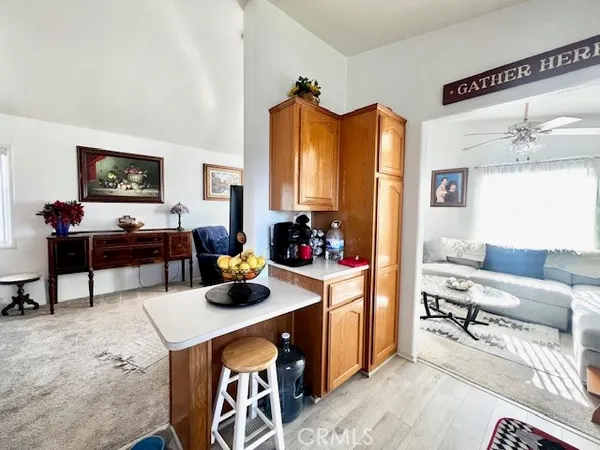 a living room with furniture a flat screen tv and a table
