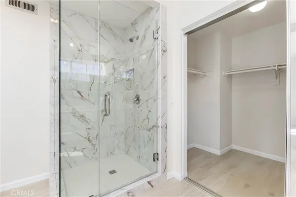 a bathroom with a glass shower door