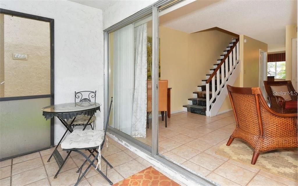2946 Clark Road, Unit 2946 Sarasota, FL 34231 - Photo 11 of 34 a view of a hallway with chairs and furniture