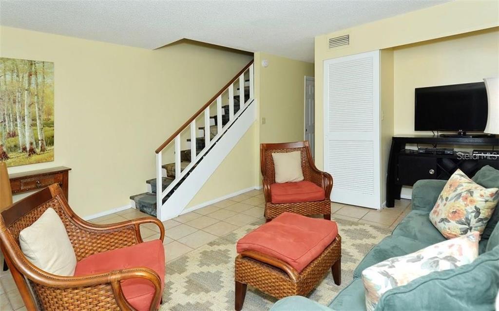 2946 Clark Road, Unit 2946 Sarasota, FL 34231 - Photo 12 of 34 a living room with furniture and a flat screen tv