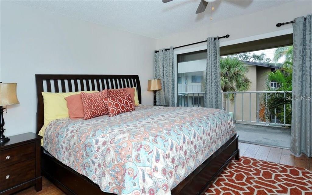 2946 Clark Road, Unit 2946 Sarasota, FL 34231 - Photo 14 of 34 a large bed sitting in a bedroom next to a window