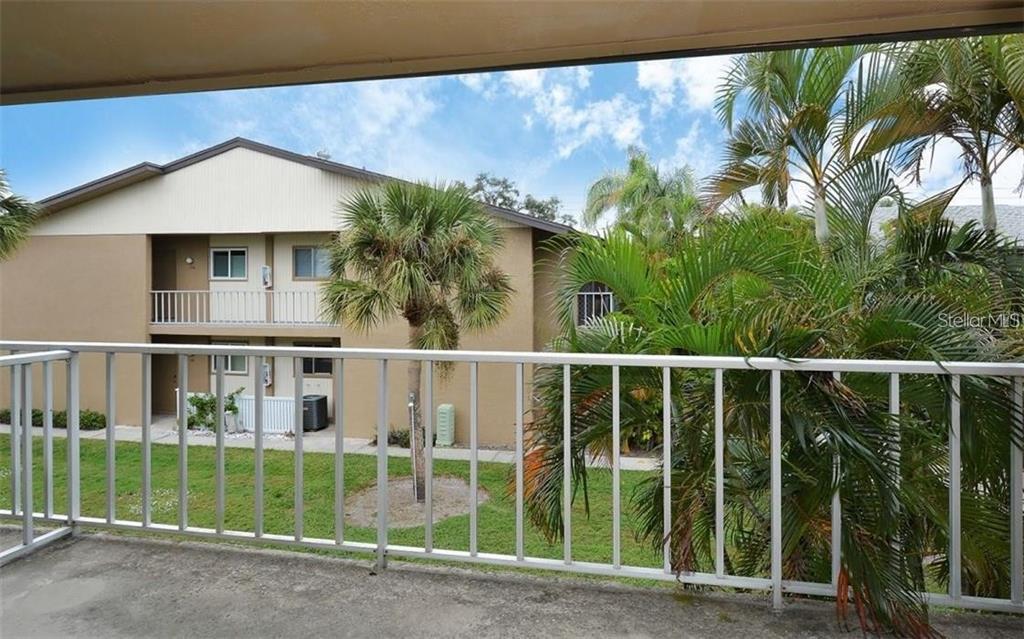 2946 Clark Road, Unit 2946 Sarasota, FL 34231 - Photo 16 of 34 a view of a house with a floor to ceiling window and plants