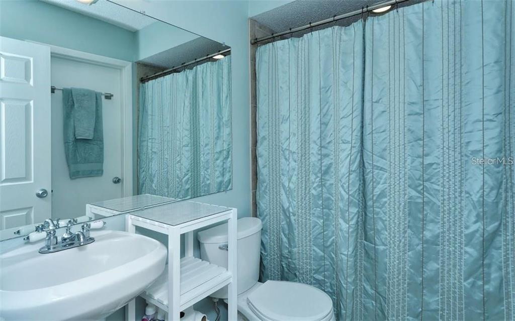 2946 Clark Road, Unit 2946 Sarasota, FL 34231 - Photo 18 of 34 a bathroom with a sink and a mirror