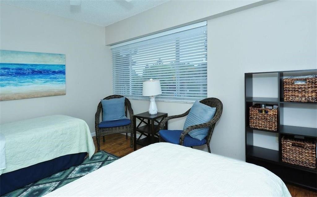 2946 Clark Road, Unit 2946 Sarasota, FL 34231 - Photo 20 of 34 a bedroom with a bed a desk and chair