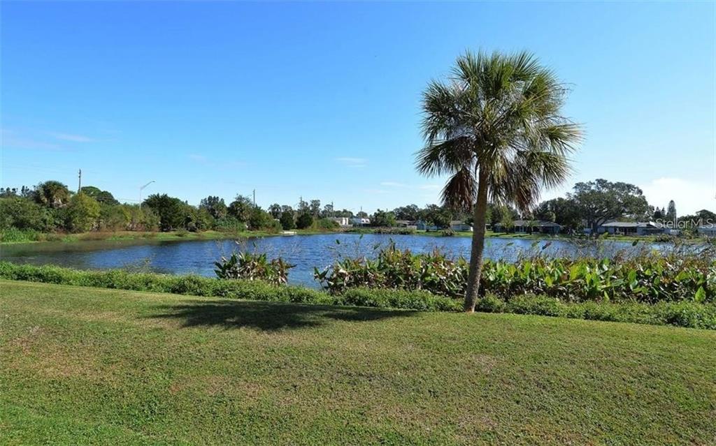 2946 Clark Road, Unit 2946 Sarasota, FL 34231 - Photo 24 of 34 a view of a lake with a big yard