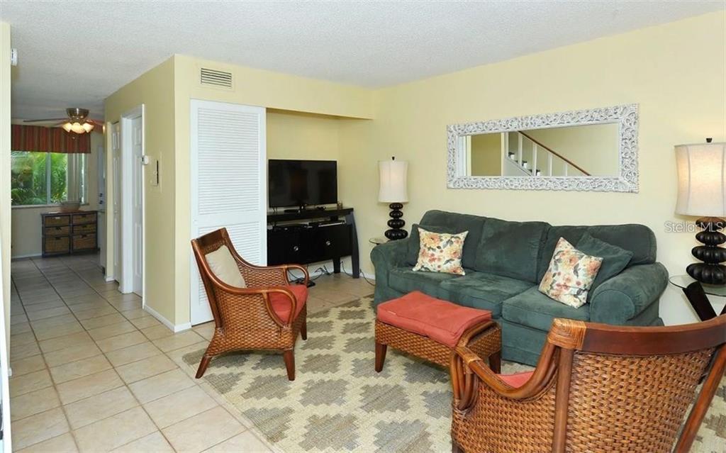 2946 Clark Road, Unit 2946 Sarasota, FL 34231 - Photo 7 of 34 a living room with furniture and a flat screen tv