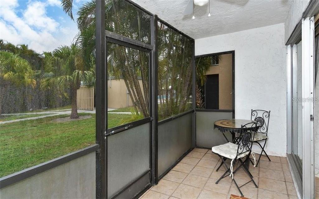 2946 Clark Road, Unit 2946 Sarasota, FL 34231 - Photo 10 of 34 a balcony with chairs and a table