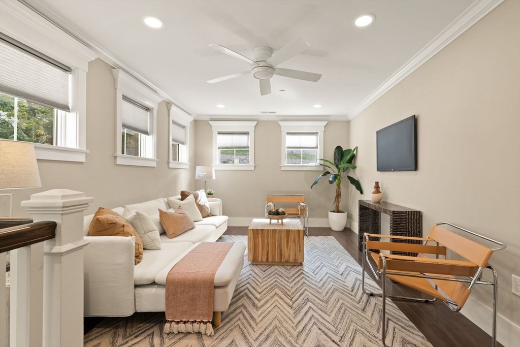 5 Gershon Way, Unit 5 Winchester, MA 01890 - Photo 20 of 27 a living room with furniture a flat screen tv and a fireplace