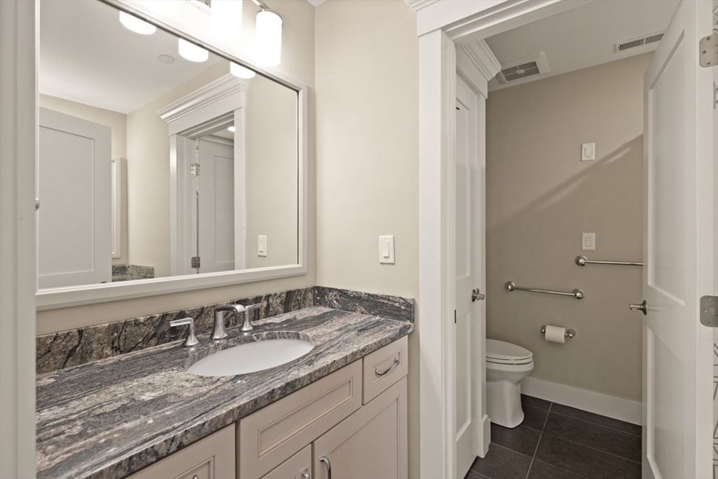 5 Gershon Way, Unit 5 Winchester, MA 01890 - Photo 22 of 27 a bathroom with a granite countertop sink and a mirror