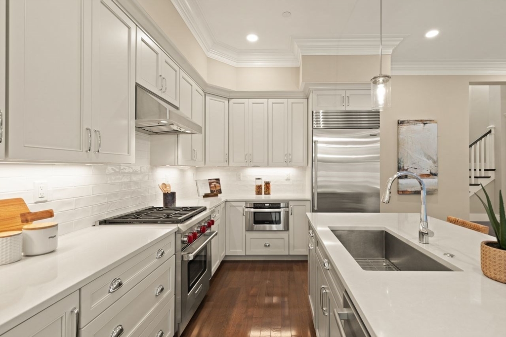 5 Gershon Way, Unit 5 Winchester, MA 01890 - Photo 8 of 27 a kitchen with a sink a stove and cabinets