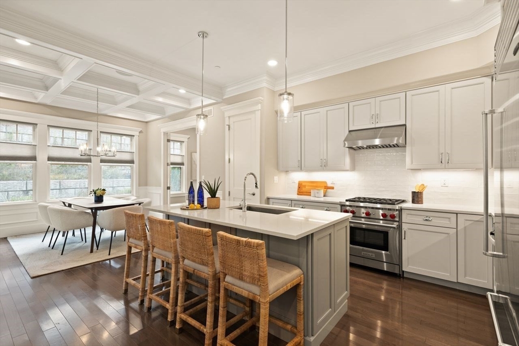 5 Gershon Way, Unit 5 Winchester, MA 01890 - Photo 9 of 27 a kitchen with a stove a sink a dining table and chairs