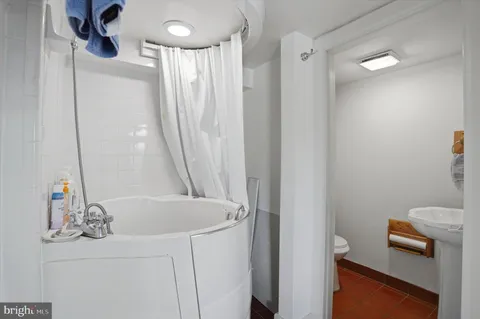 a bathroom with a bathtub a sink and a shower