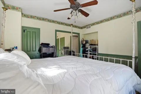 a bedroom with a large bed and a chandelier