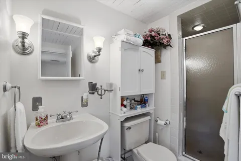 a bathroom with a sink toilet and mirror