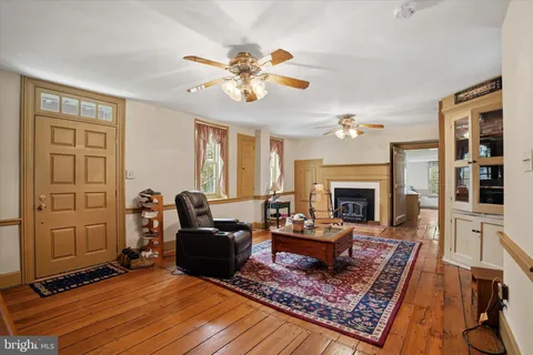 a living room with furniture a fireplace and a table