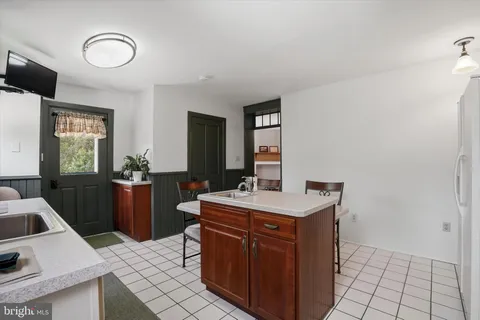 a kitchen with a stove a sink and a refrigerator