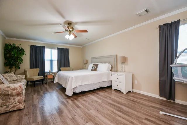 a spacious bedroom with a bed and a chandelier