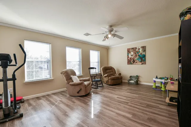 a living room with furniture window and wooden floor